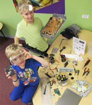 boys with machines at tech take apart day